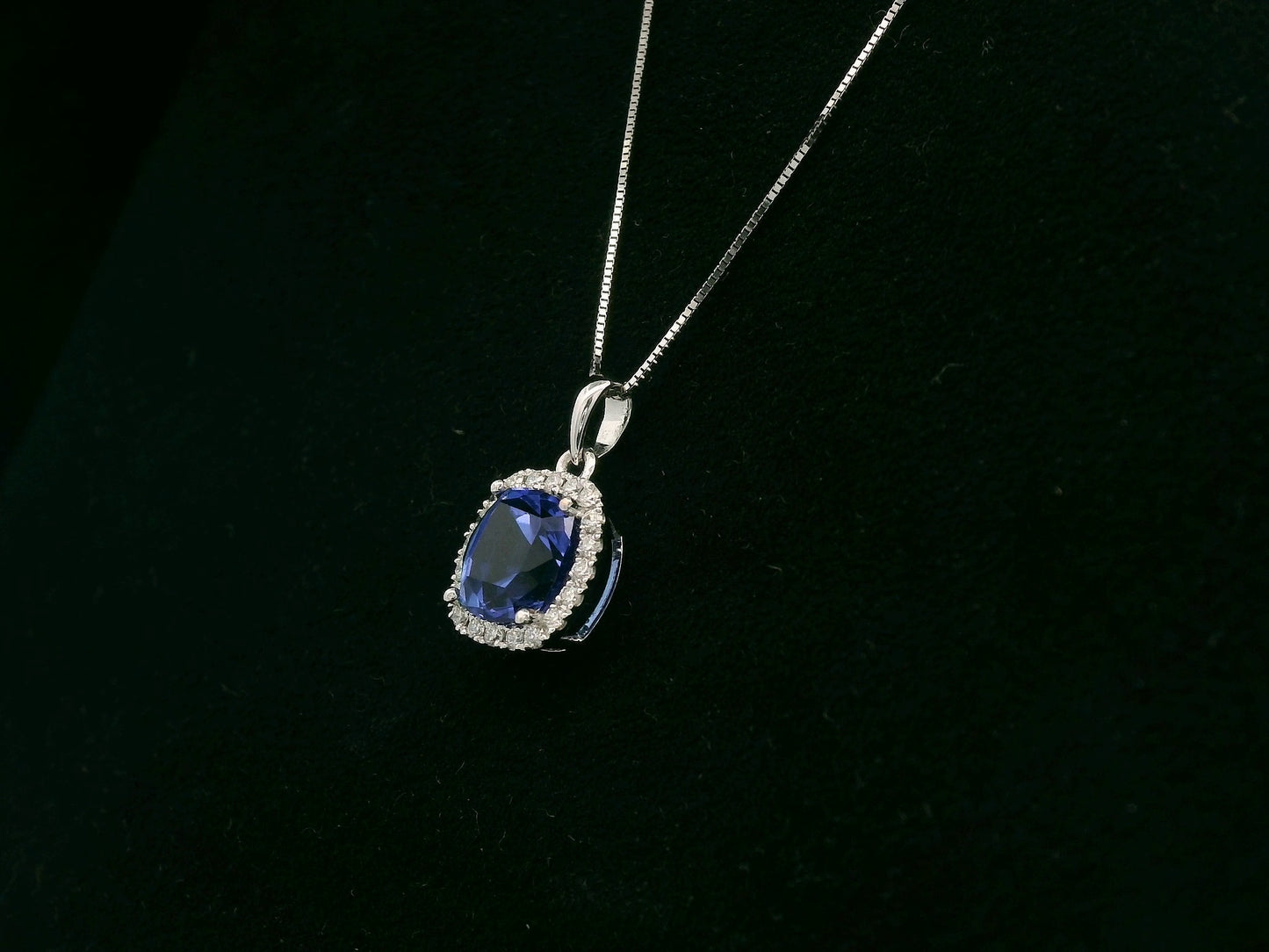 18K white gold Tanzanite and diamond halo pendant with cushion-cut 2.02 carat center stone