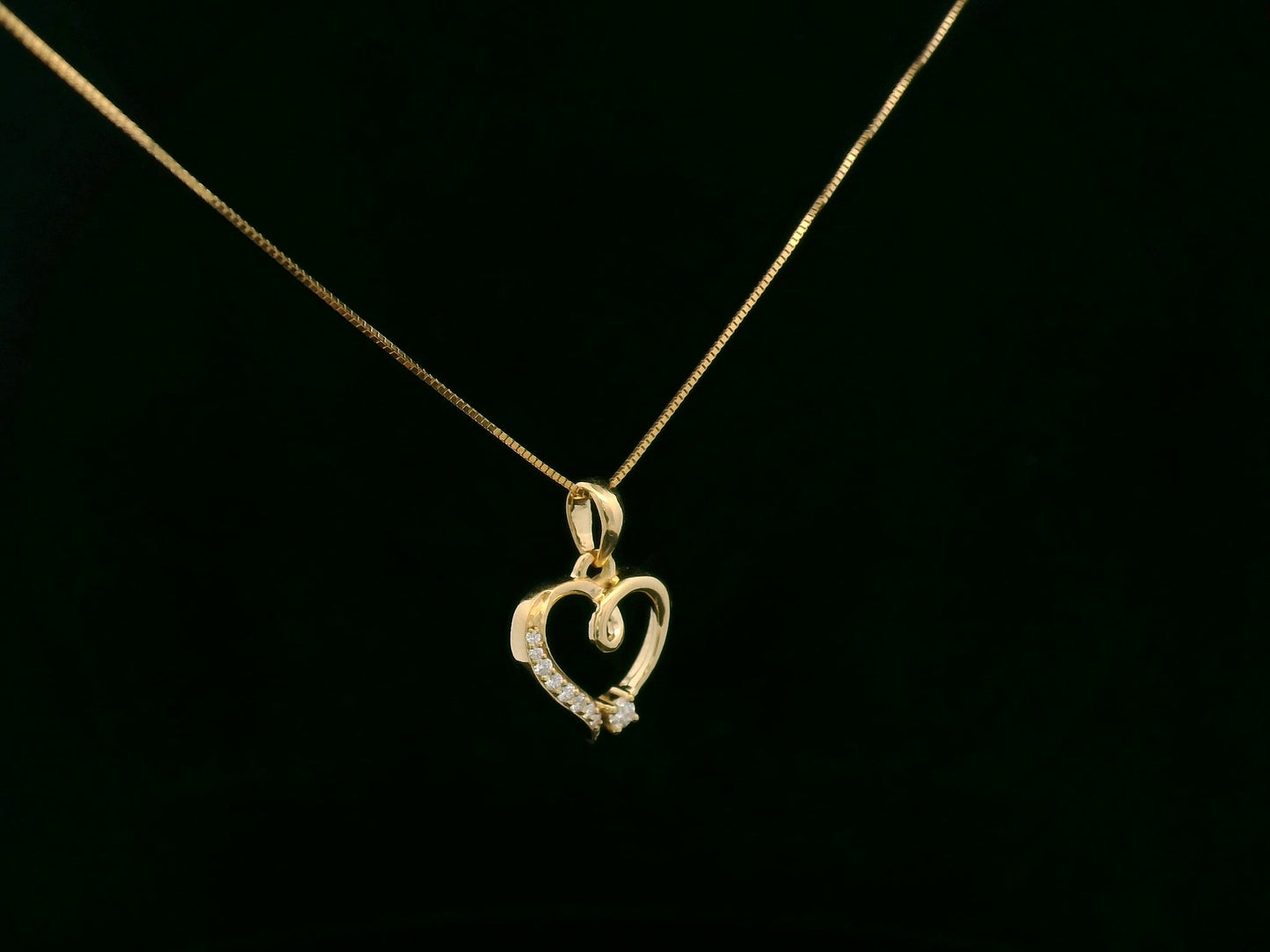 18K yellow gold diamond heart pendant with delicate open-heart design by Emirates Diamonds.