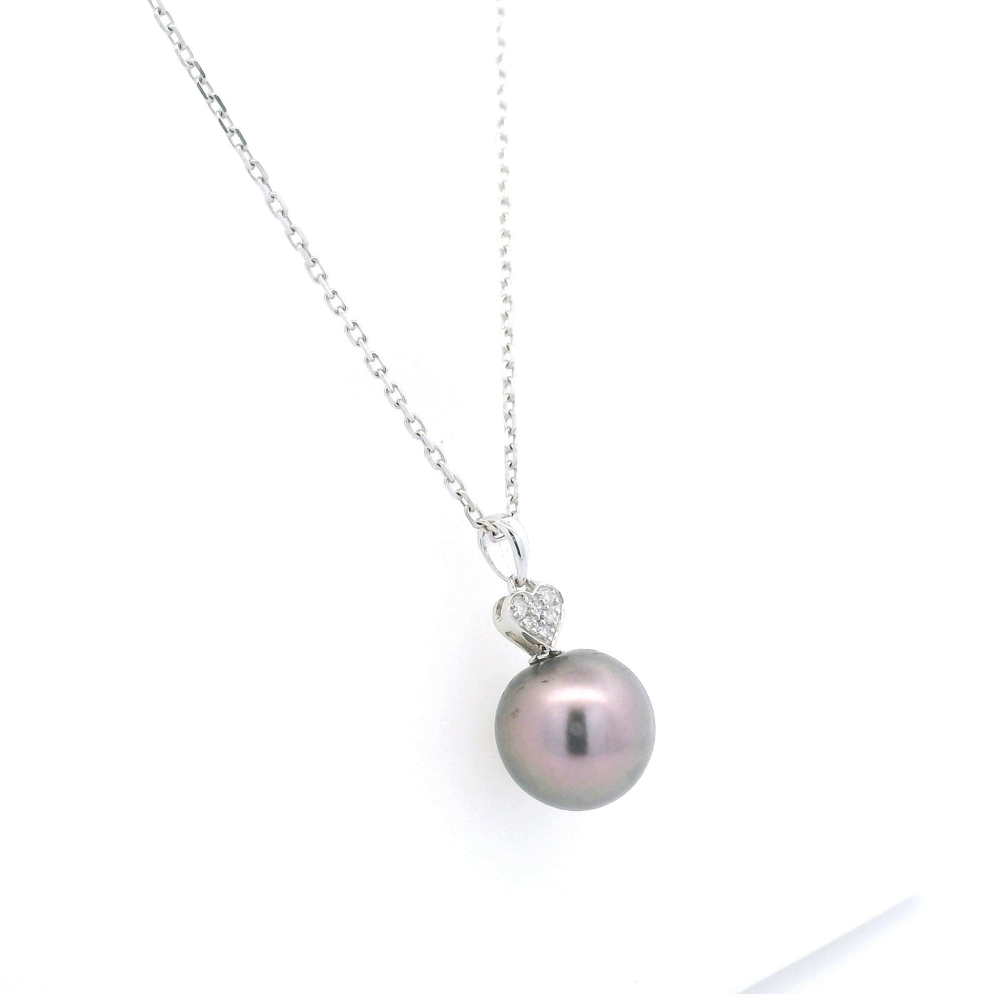 Tahitian black pearl diamond heart pendant in 18K white gold with natural diamond accent.