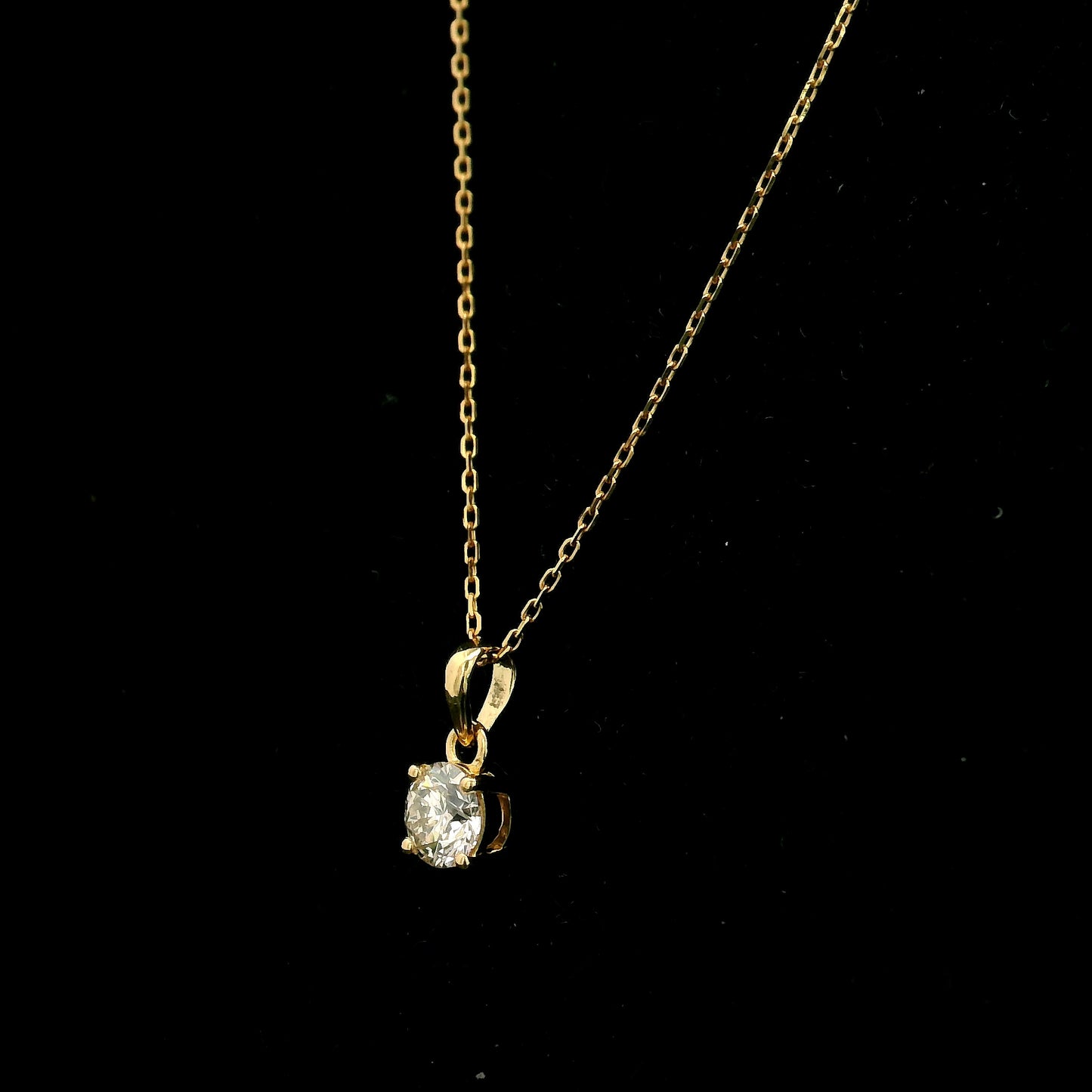 18K yellow gold solitaire pendant featuring a 0.70 carat GIA certified round brilliant natural diamond in a classic four-prong setting, supplied without a chain.