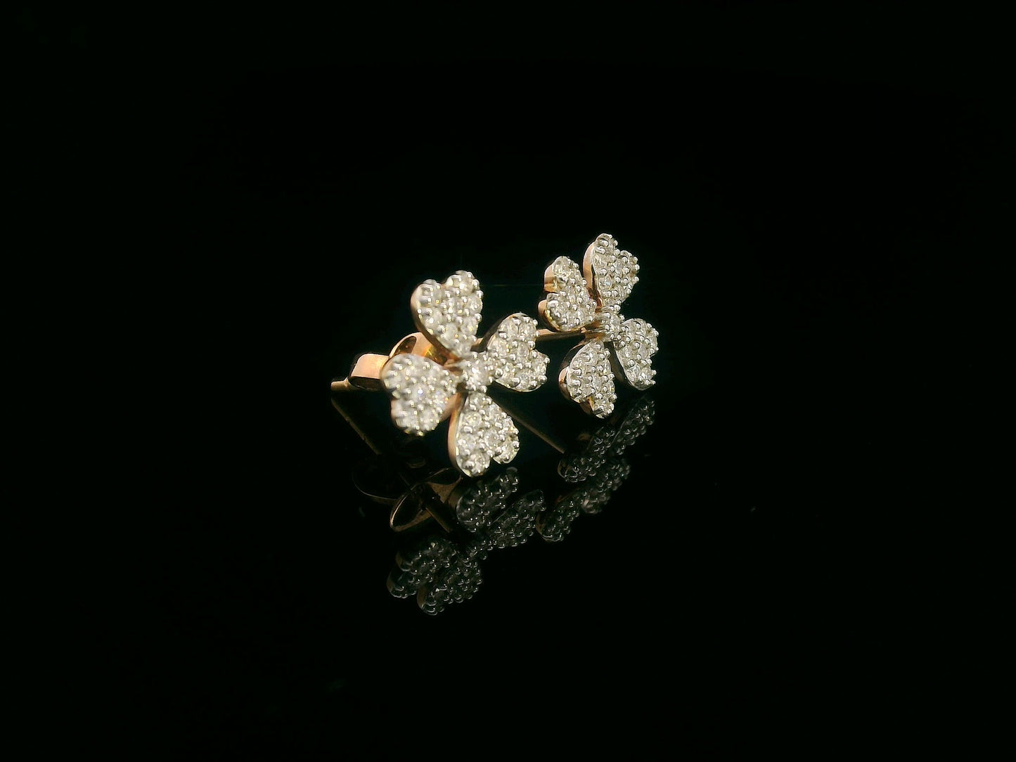 Diamond floral stud earrings with heart-shaped petals in 18K gold, 0.46 carat total weight