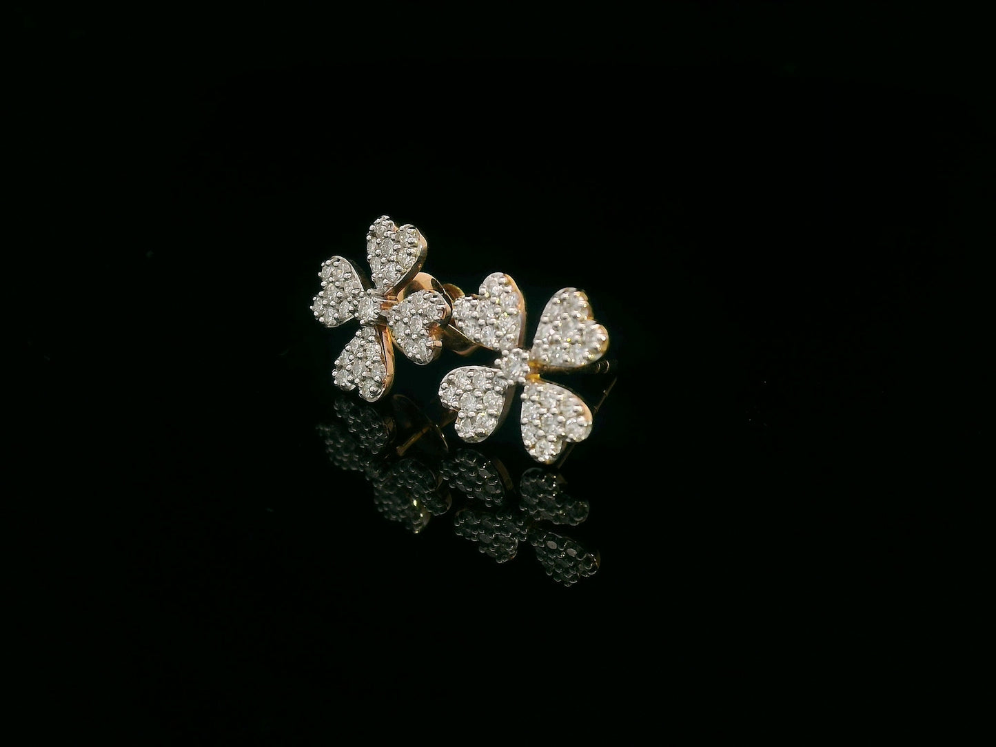 Diamond floral stud earrings with heart-shaped petals in 18K gold, 0.46 carat total weight