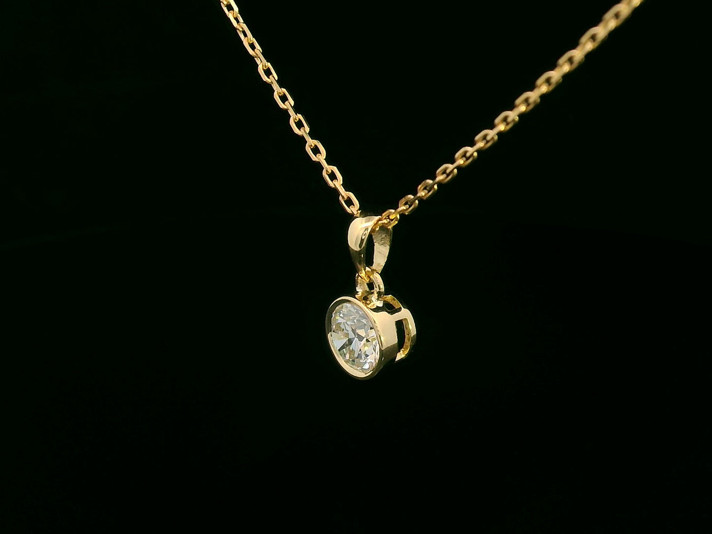 Bezel set 0.56ct round diamond pendant in 18K yellow gold without chain – minimal solitaire necklace