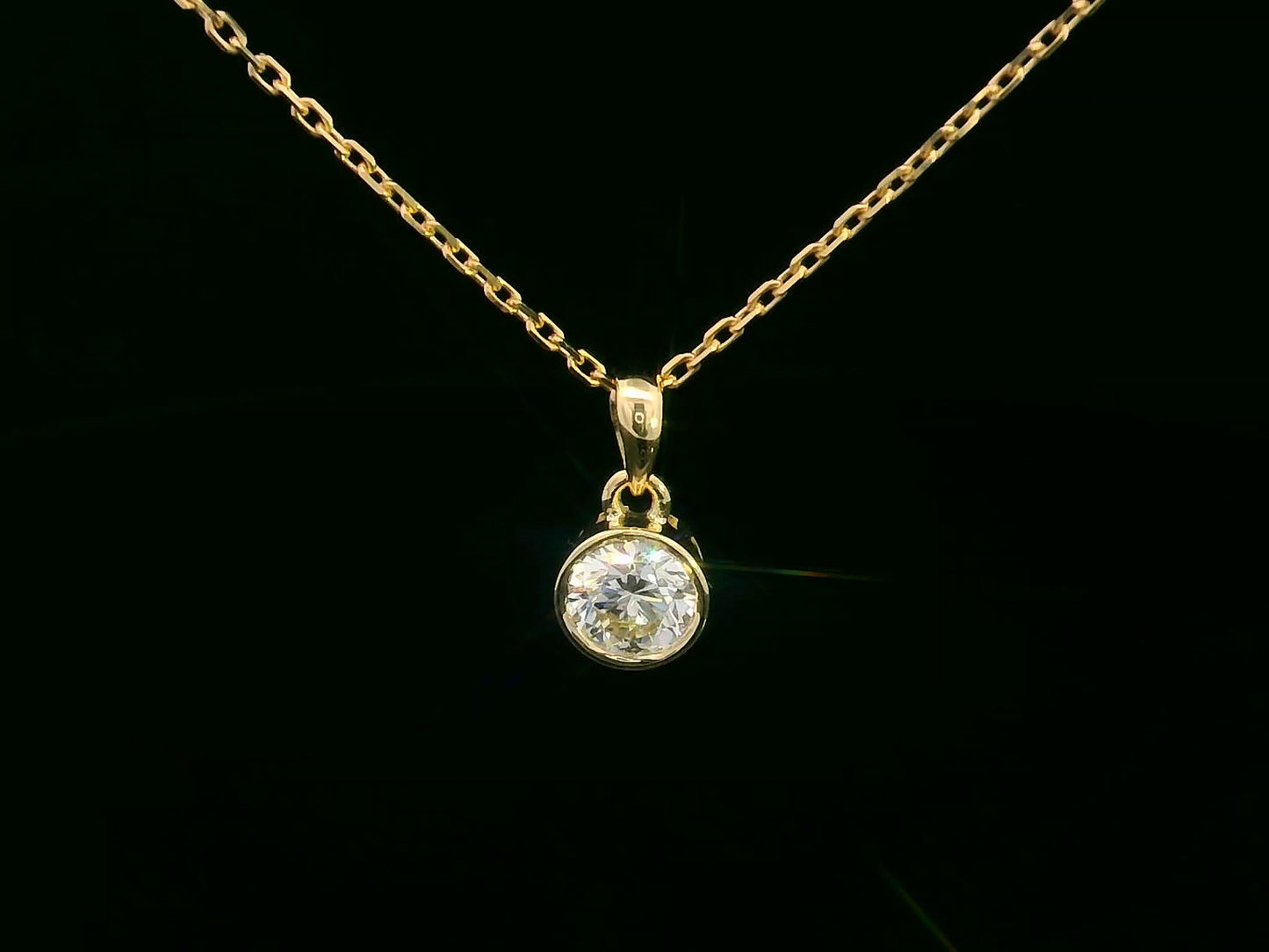 Bezel set 0.56ct round diamond pendant in 18K yellow gold without chain – minimal solitaire necklace