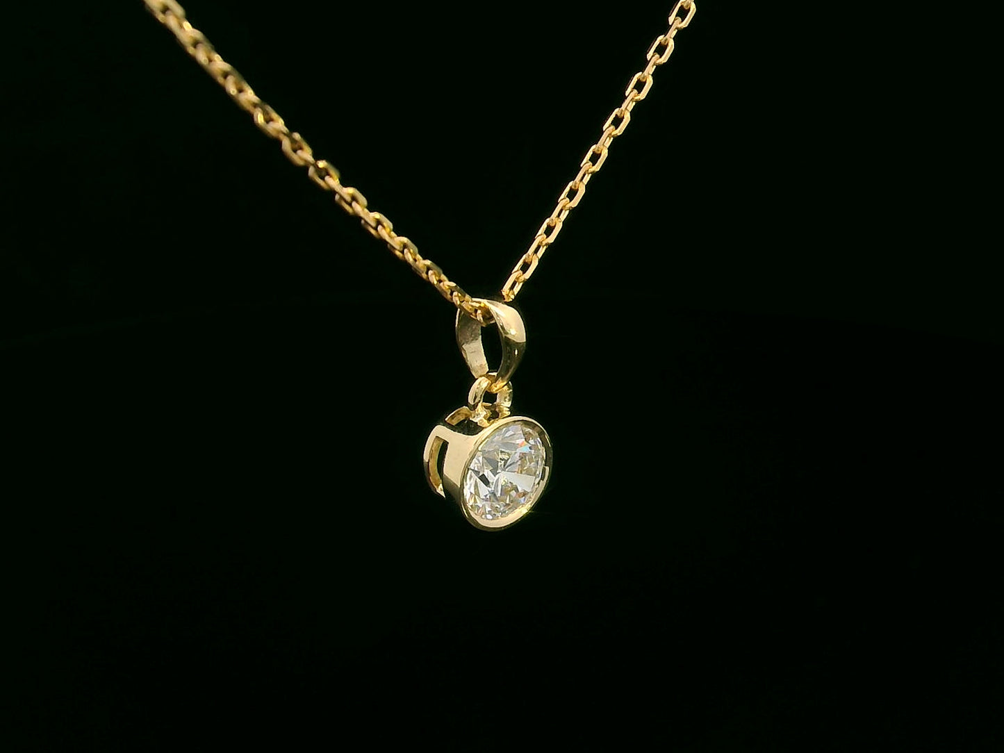 Bezel set 0.56ct round diamond pendant in 18K yellow gold without chain – minimal solitaire necklace