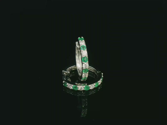 Round hoop earrings featuring 0.34 carat diamonds and 0.35 carat emeralds in white gold