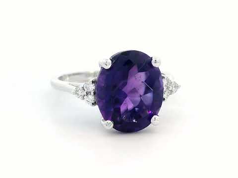18K gold ring featuring a 4.37-carat oval-cut amethyst, accented by 0.13 carats of round diamonds.