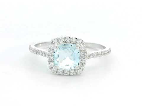 18K white gold ring with cushion-cut aquamarine center and diamond halo and band