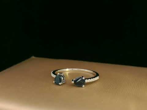 18K white gold open cuff ring with two teardrop-cut blue sapphires (0.70 carat) and 0.10 carat diamond pavé, modern minimalist design