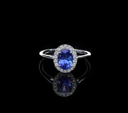 Tanzanite and diamond ring in 18K white gold with oval tanzanite and round diamond halo