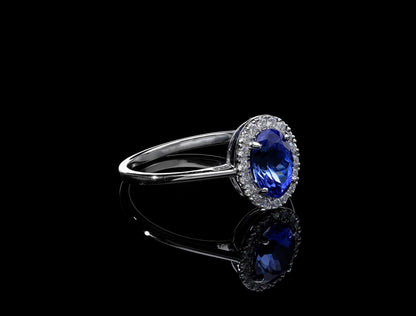 Tanzanite and diamond ring in 18K white gold with oval tanzanite and round diamond halo