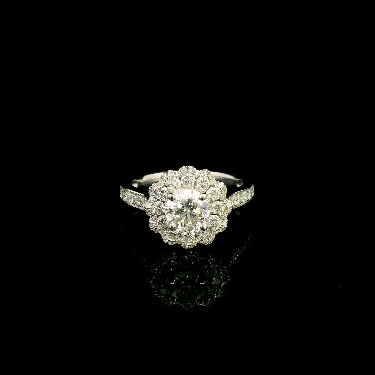 18K white gold diamond halo engagement ring featuring a 1 Carat round brilliant centre diamond with 0.79 Carat natural diamond halo and shoulders.