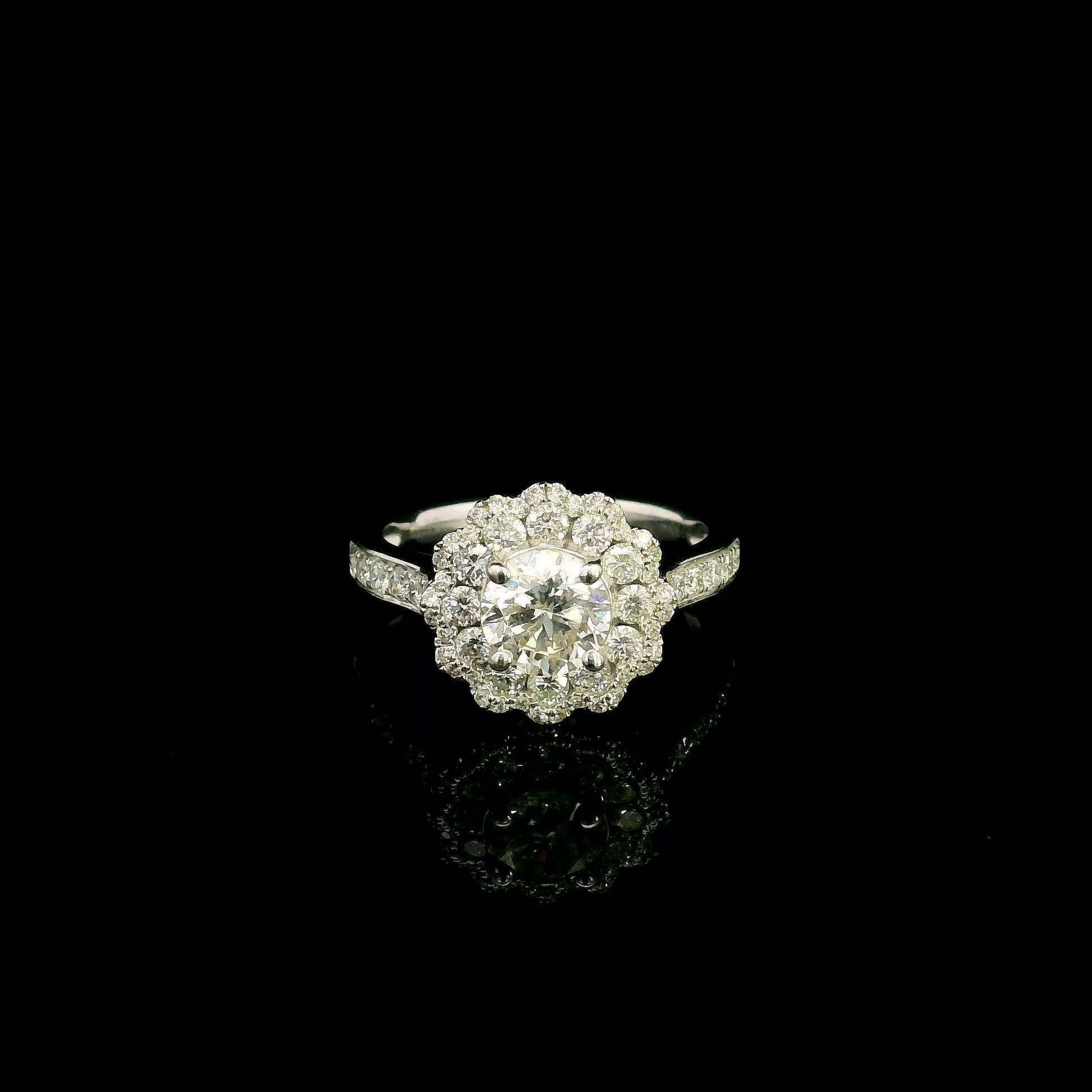 18K white gold diamond halo engagement ring featuring a 1 Carat round brilliant centre diamond with 0.79 Carat natural diamond halo and shoulders.