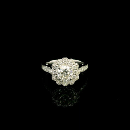 18K white gold diamond halo engagement ring featuring a 1 Carat round brilliant centre diamond with 0.79 Carat natural diamond halo and shoulders.