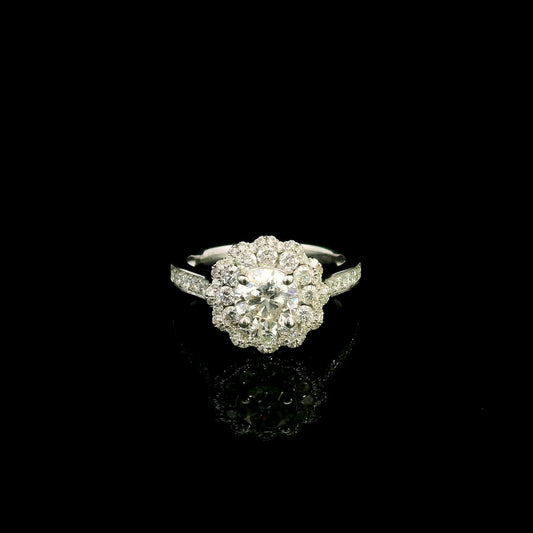 18K white gold diamond halo engagement ring featuring a 1 Carat round brilliant centre diamond with 0.79 Carat natural diamond halo and shoulders.