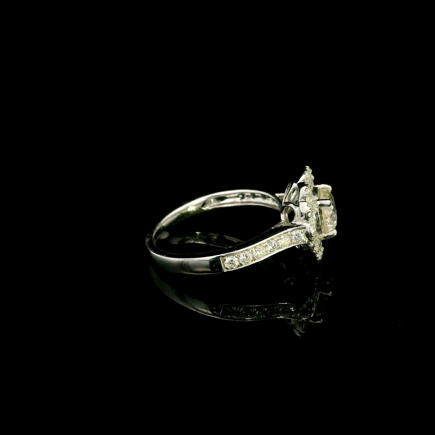 18K white gold diamond halo engagement ring featuring a 1 Carat round brilliant centre diamond with 0.79 Carat natural diamond halo and shoulders.