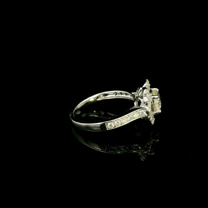 18K white gold diamond halo engagement ring featuring a 1 Carat round brilliant centre diamond with 0.79 Carat natural diamond halo and shoulders.