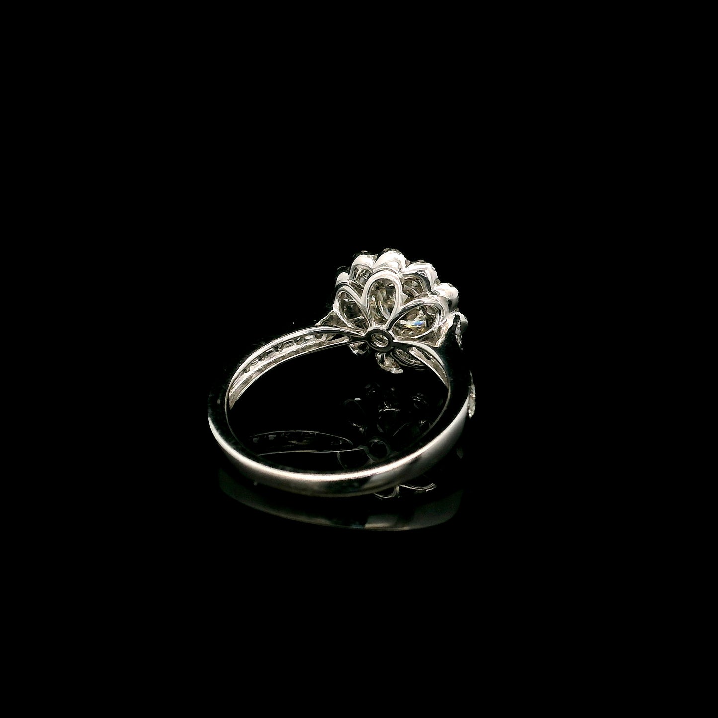 18K white gold diamond halo engagement ring featuring a 1 Carat round brilliant centre diamond with 0.79 Carat natural diamond halo and shoulders.