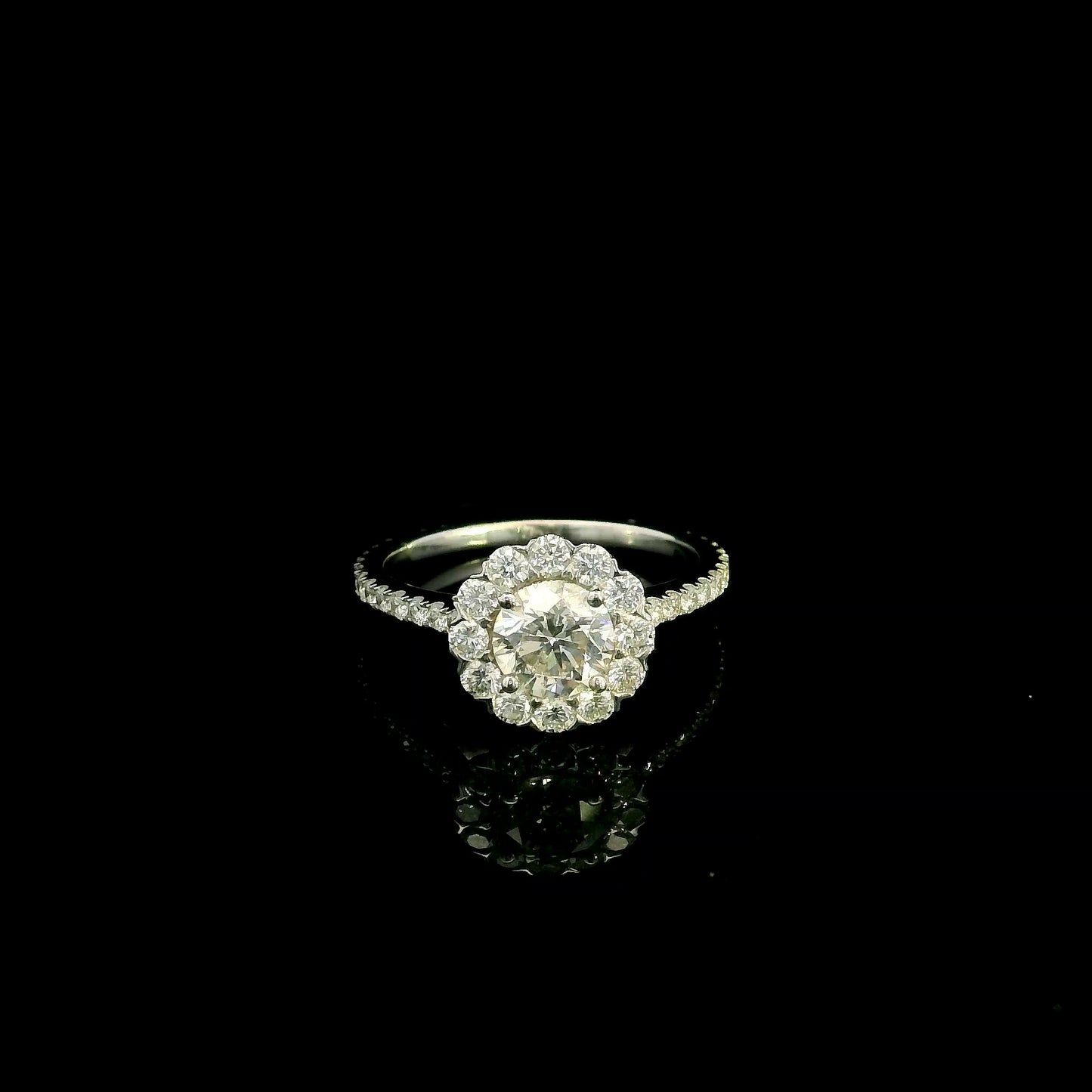 18K white gold halo diamond engagement ring featuring a 1.00 carat natural round brilliant diamond surrounded by a floral halo with pavé diamond band.