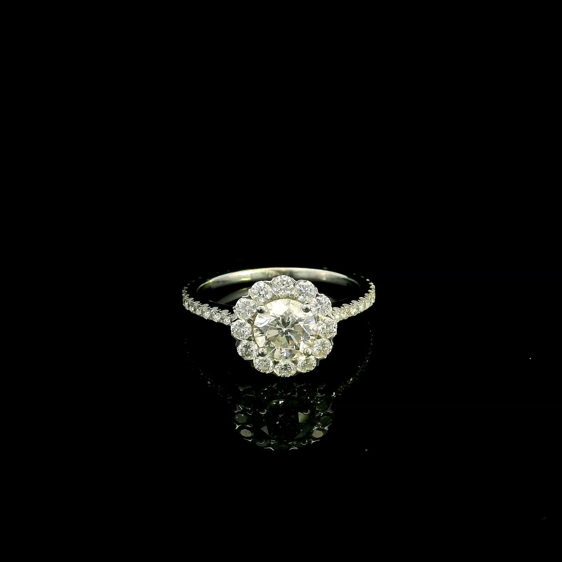 18K white gold halo diamond engagement ring featuring a 1.00 carat natural round brilliant diamond surrounded by a floral halo with pavé diamond band.