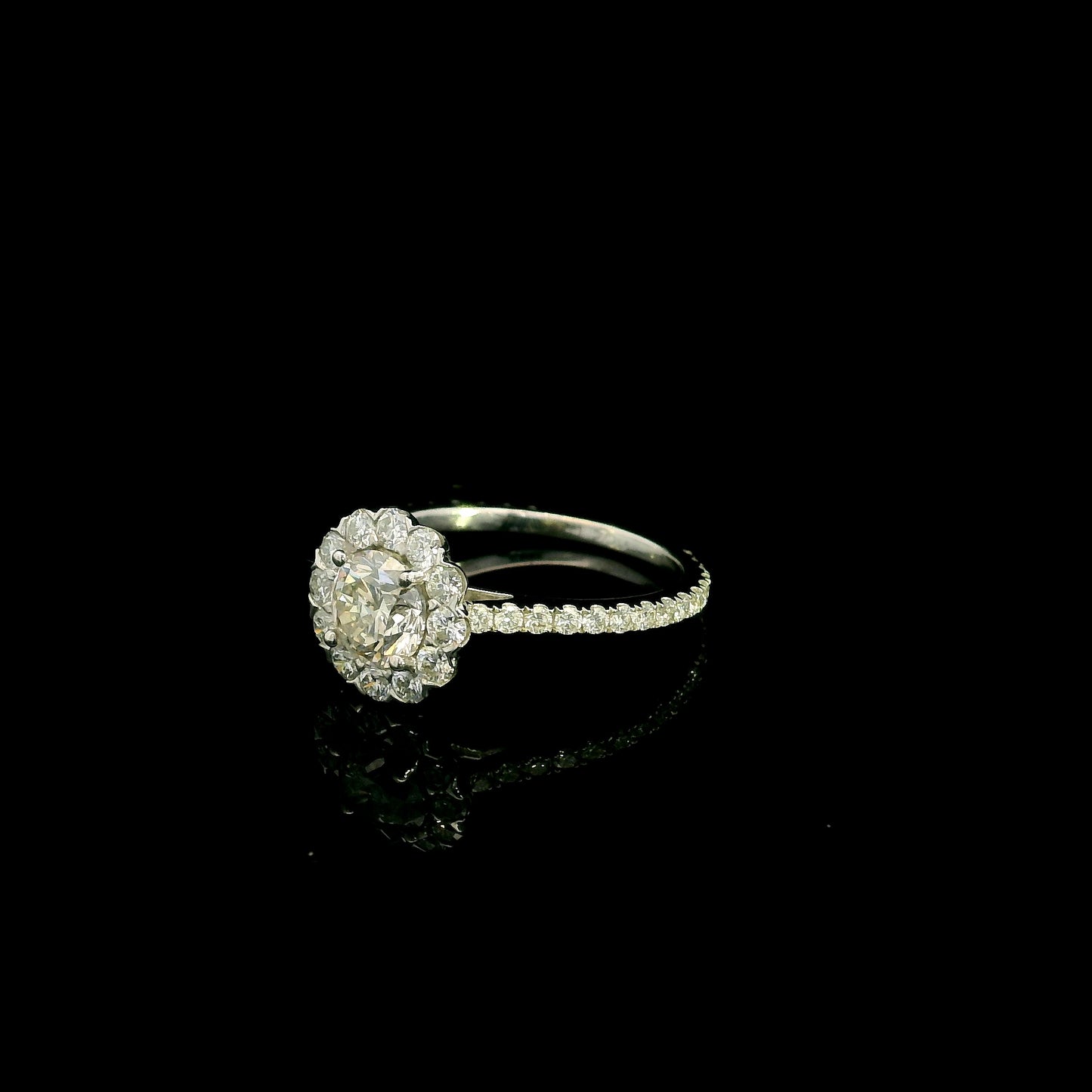 18K white gold halo diamond engagement ring featuring a 1.00 carat natural round brilliant diamond surrounded by a floral halo with pavé diamond band.