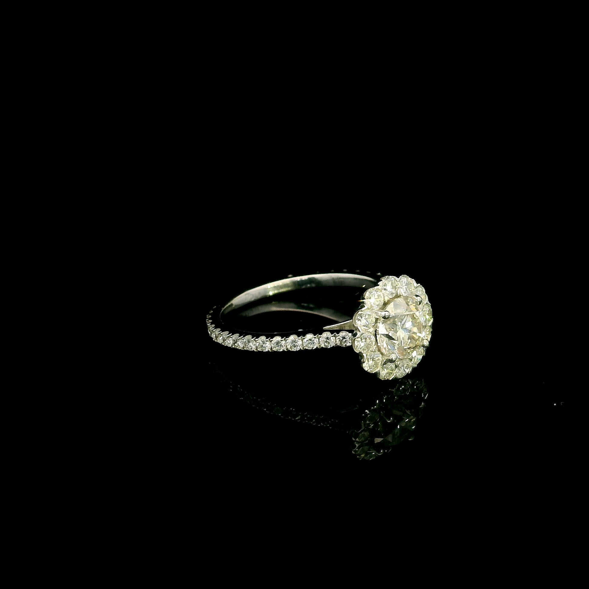18K white gold halo diamond engagement ring featuring a 1.00 carat natural round brilliant diamond surrounded by a floral halo with pavé diamond band.