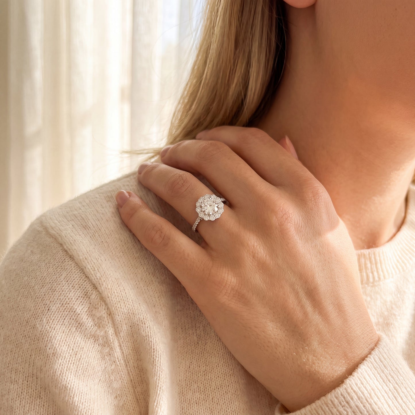 18K white gold halo diamond engagement ring featuring a 1.00 carat natural round brilliant diamond surrounded by a floral halo with pavé diamond band.
