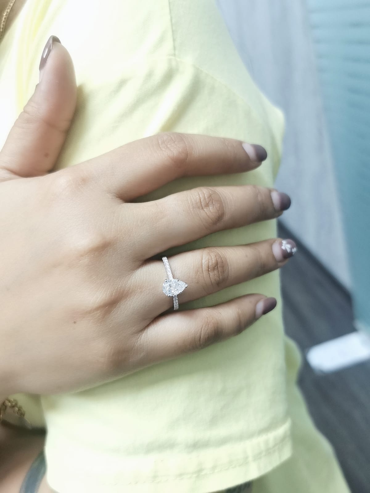 18K Gold Engagement Ring With 1.01 Carat Pear-Shaped Diamond And Accent Diamonds.