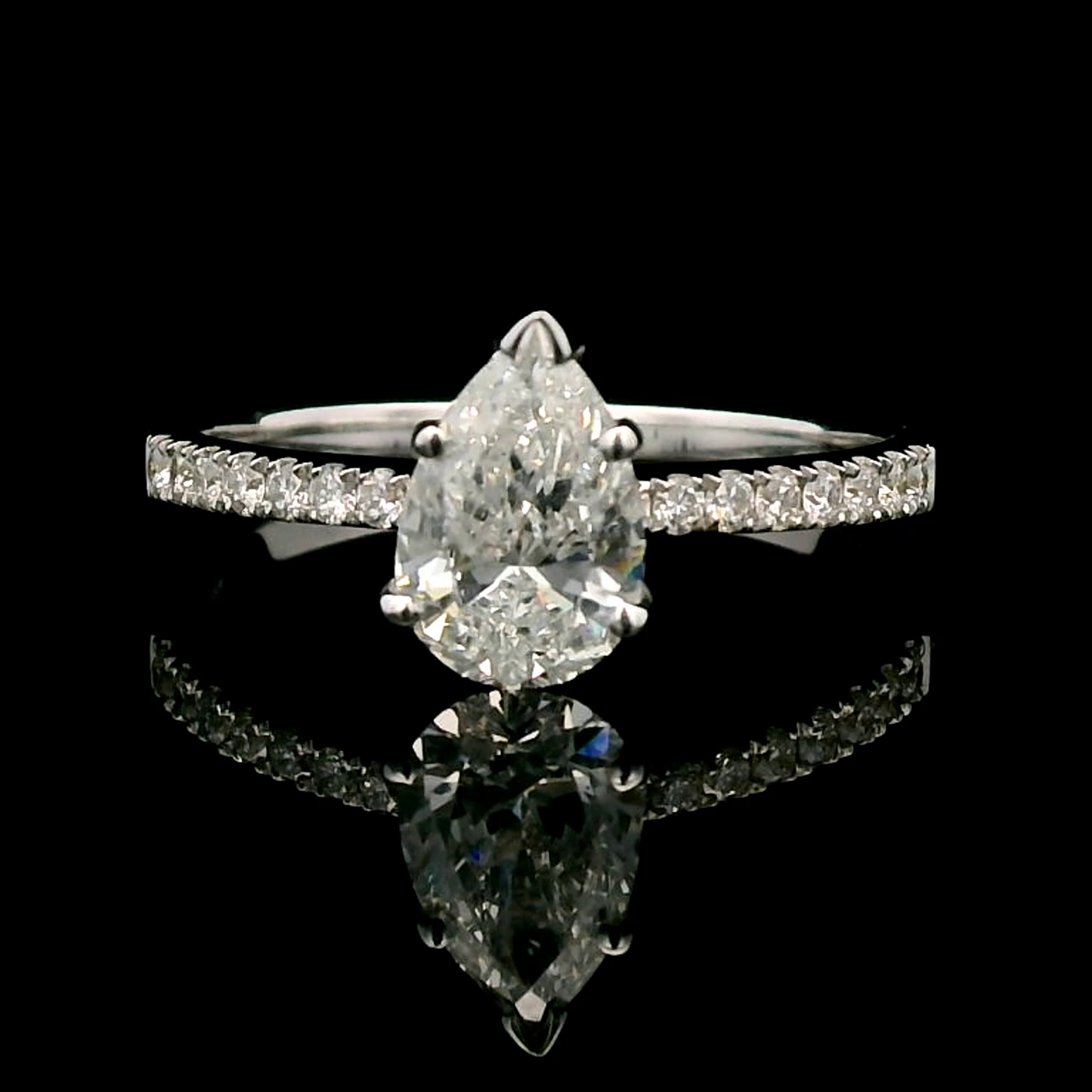 18K Gold Engagement Ring With 1.01 Carat Pear-Shaped Diamond And Accent Diamonds.