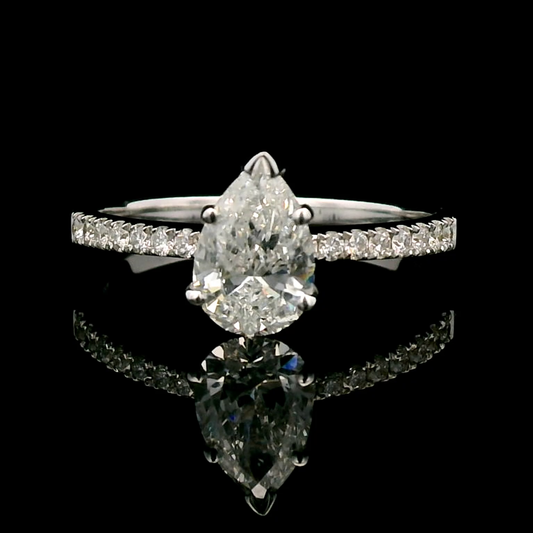 18K Gold Engagement Ring With 1.01 Carat Pear-Shaped Diamond And Accent Diamonds.