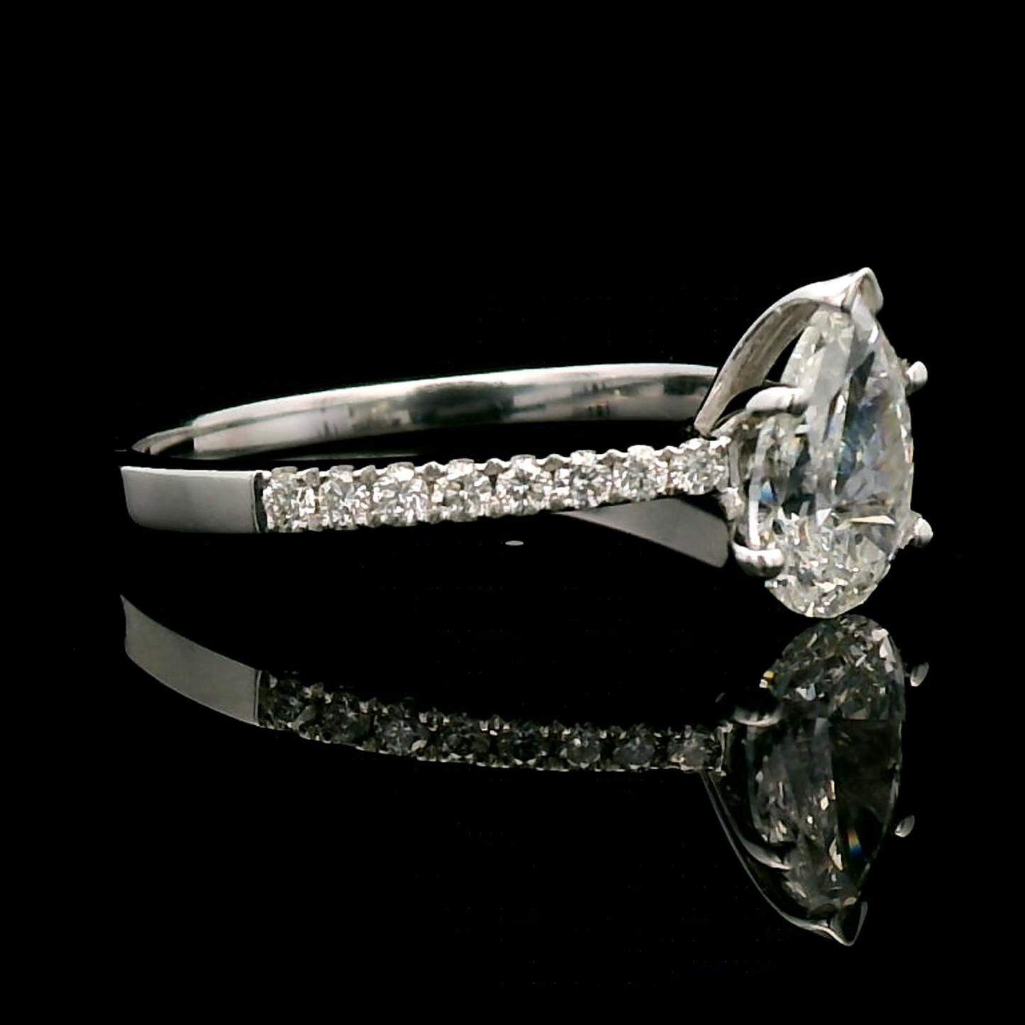 18K Gold Engagement Ring With 1.01 Carat Pear-Shaped Diamond And Accent Diamonds.