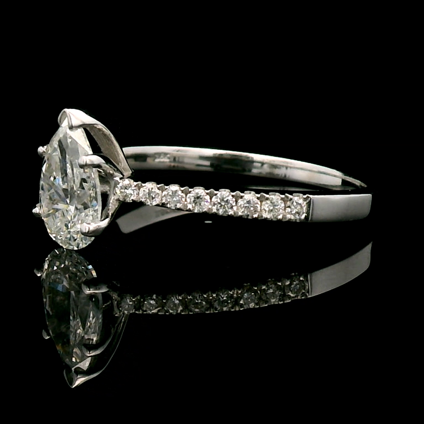 18K Gold Engagement Ring With 1.01 Carat Pear-Shaped Diamond And Accent Diamonds.