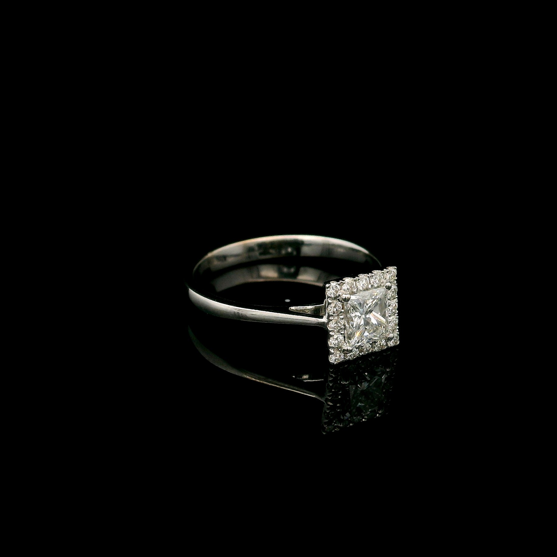 18K white gold princess cut diamond halo engagement ring featuring a 0.71 carat IGI certified E VS2 diamond with a sparkling natural diamond halo.