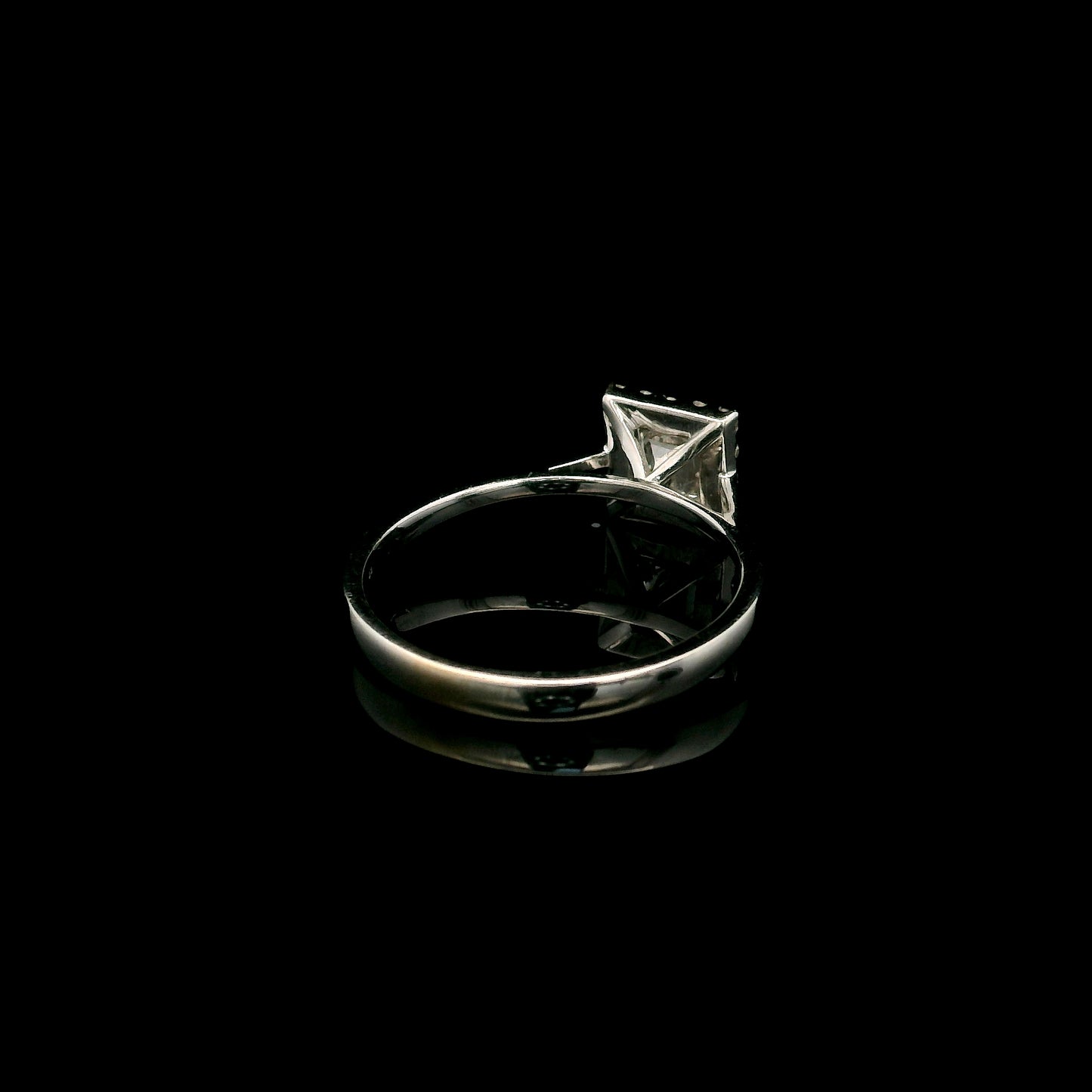 18K white gold princess cut diamond halo engagement ring featuring a 0.71 carat IGI certified E VS2 diamond with a sparkling natural diamond halo.
