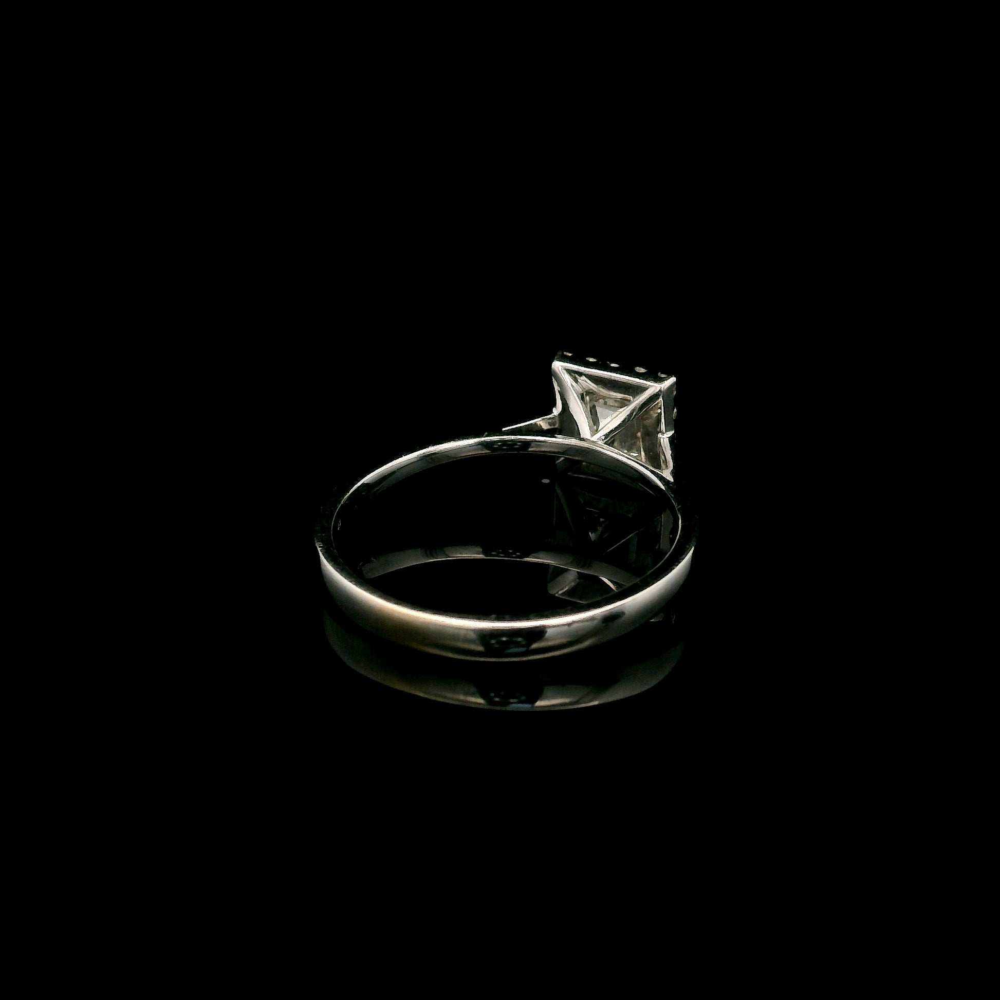 18K white gold princess cut diamond halo engagement ring featuring a 0.71 carat IGI certified E VS2 diamond with a sparkling natural diamond halo.