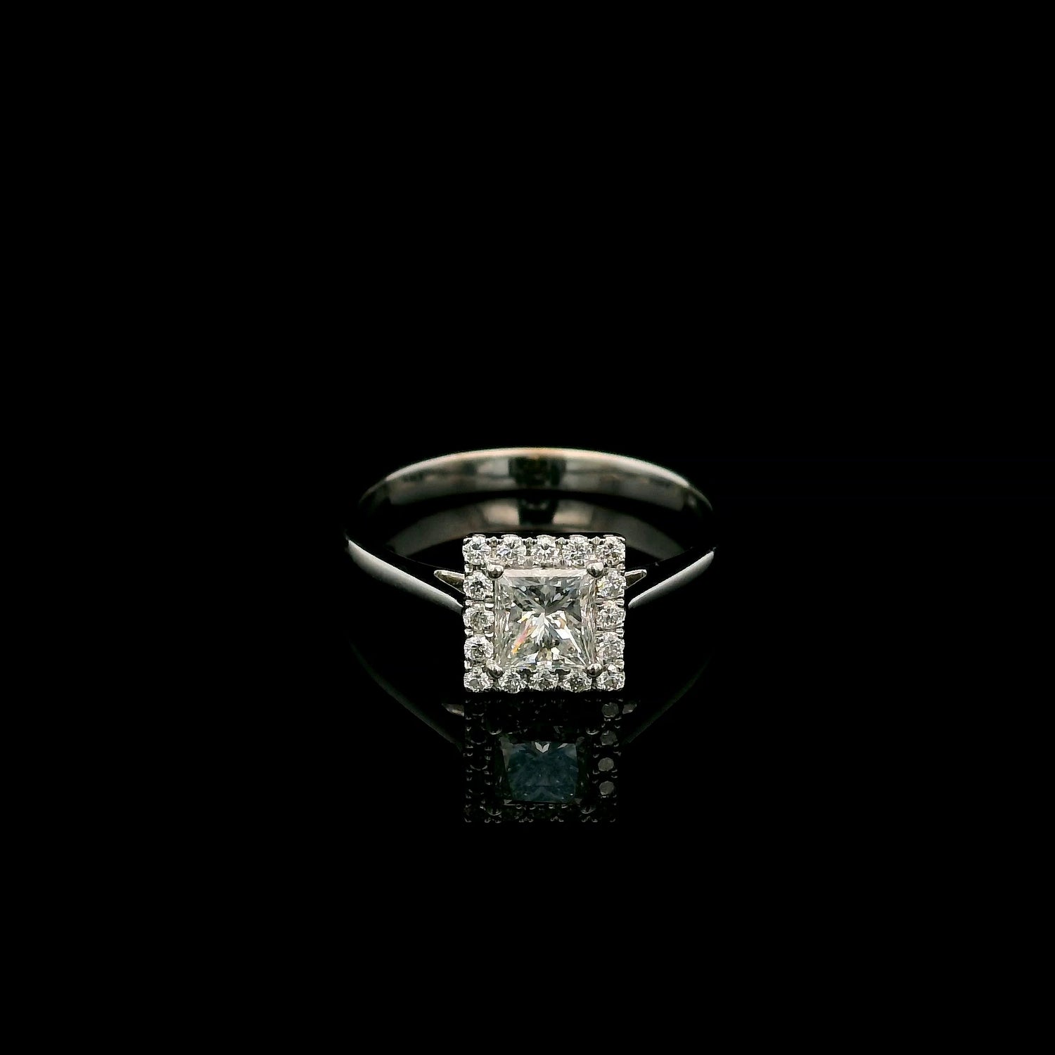 18K white gold princess cut diamond halo engagement ring featuring a 0.71 carat IGI certified E VS2 diamond with a sparkling natural diamond halo.