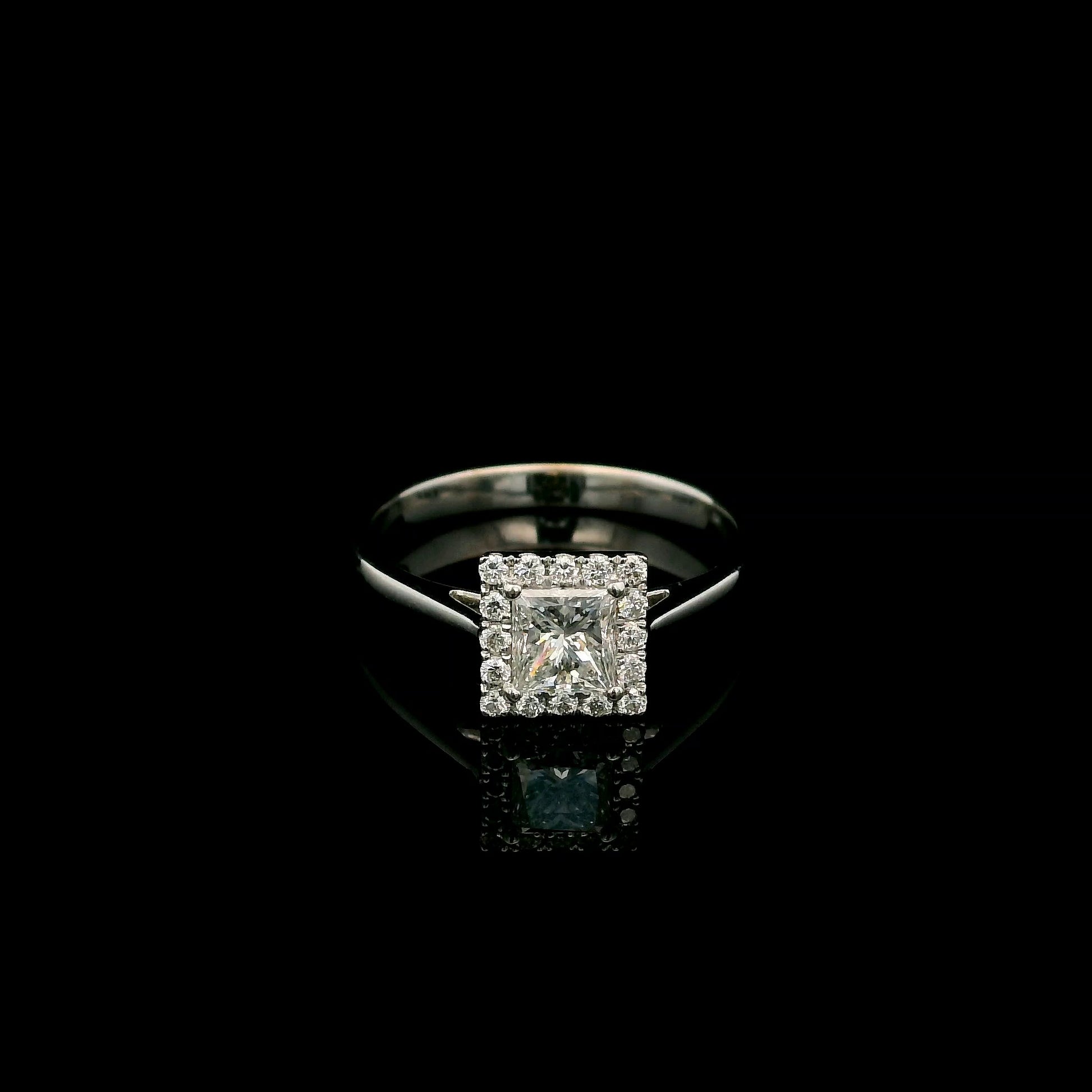 18K white gold princess cut diamond halo engagement ring featuring a 0.71 carat IGI certified E VS2 diamond with a sparkling natural diamond halo.