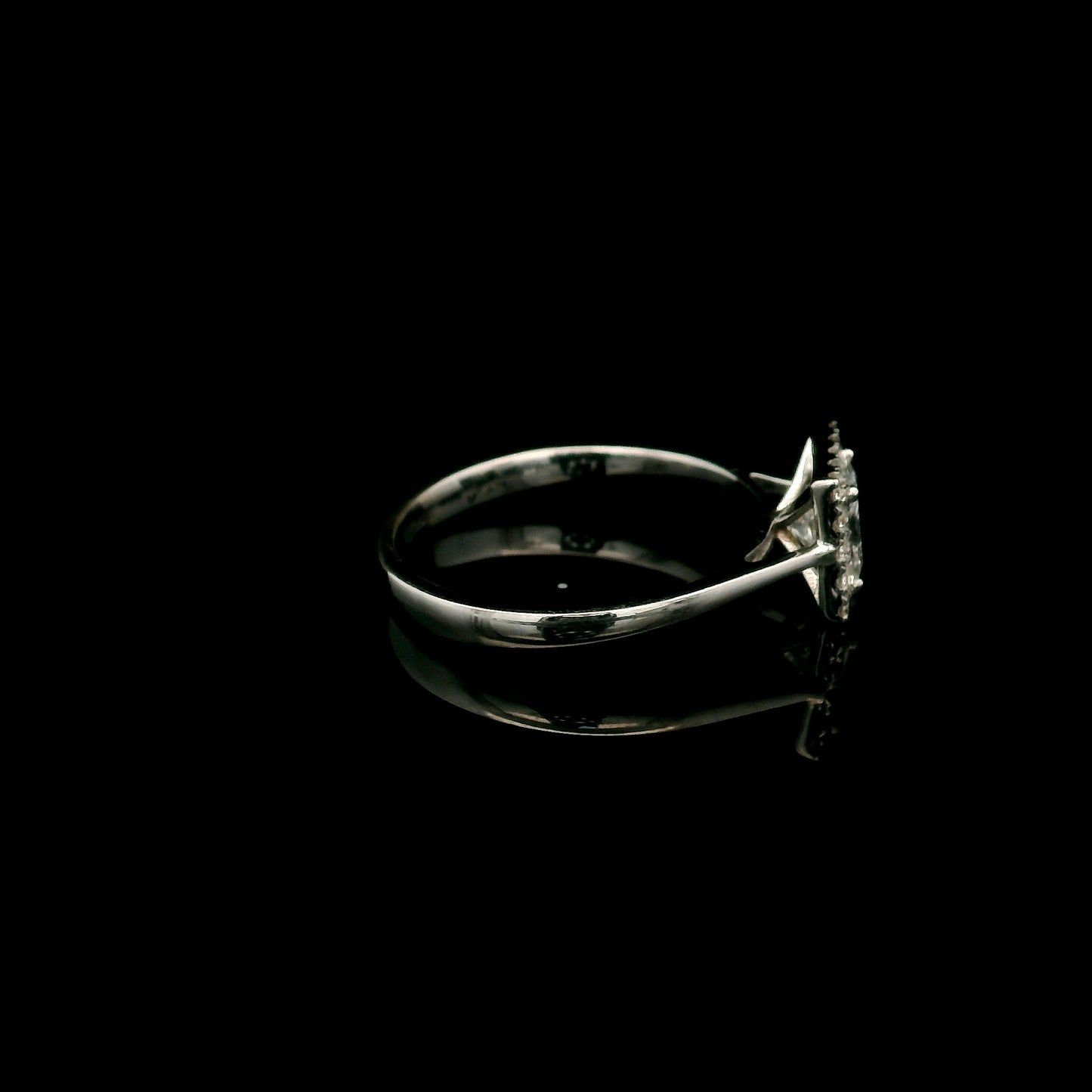 18K white gold princess cut diamond halo engagement ring featuring a 0.71 carat IGI certified E VS2 diamond with a sparkling natural diamond halo.