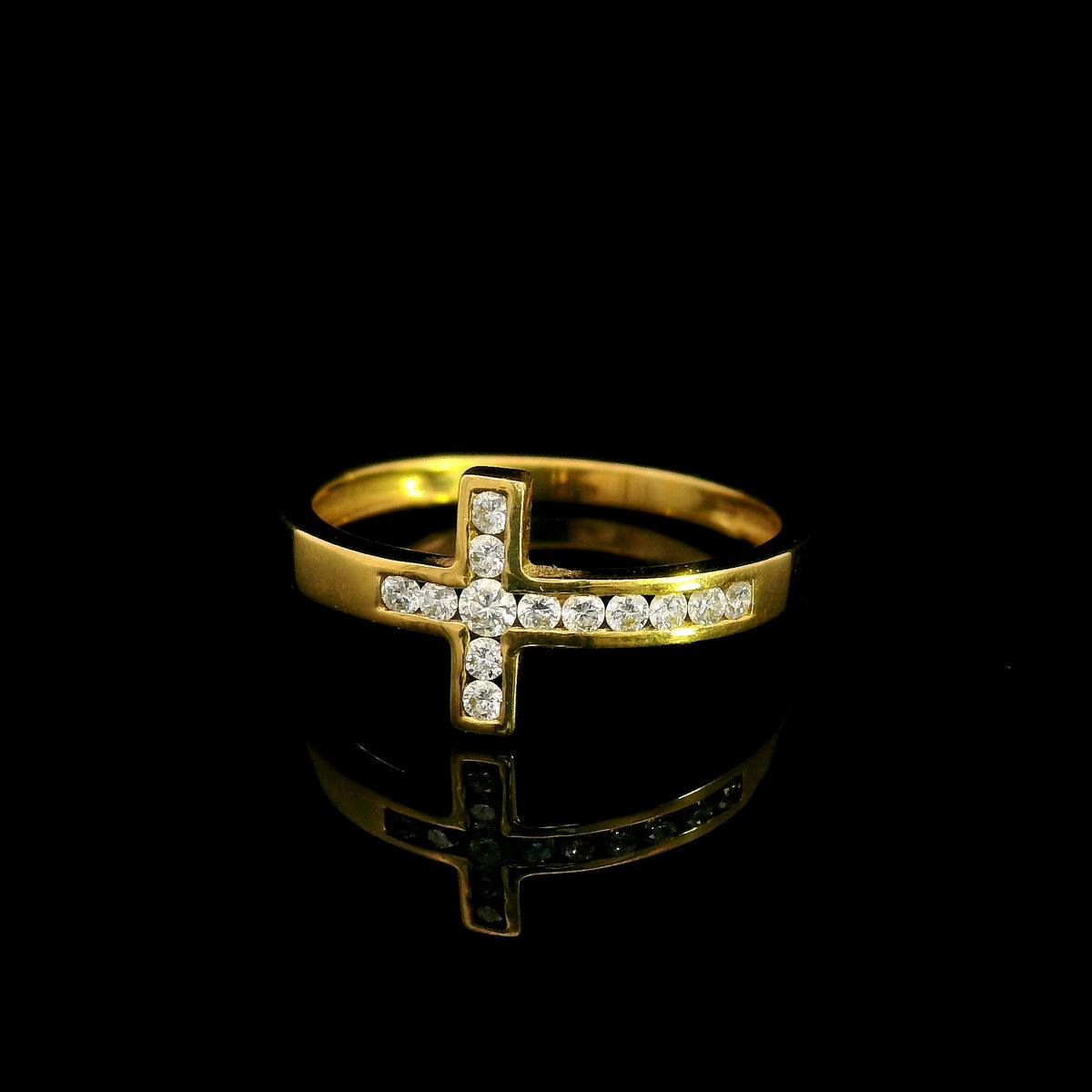 Diamond cross ring in 18K yellow gold featuring round brilliant diamonds set across a polished gold band in a distinctive cross design.