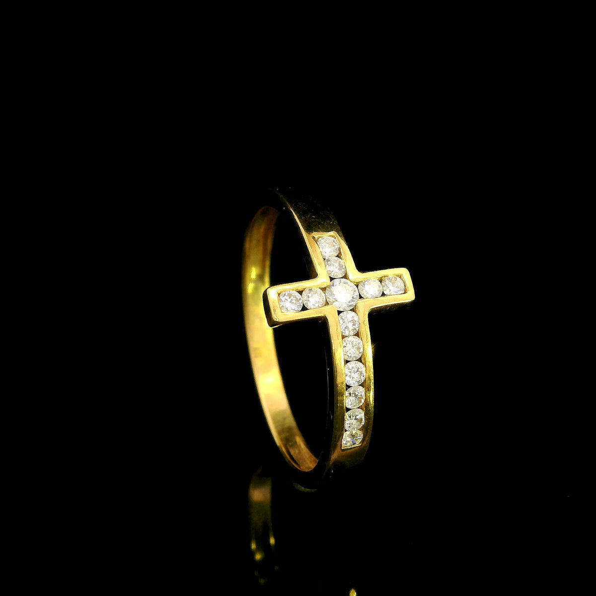Diamond cross ring in 18K yellow gold featuring round brilliant diamonds set across a polished gold band in a distinctive cross design.