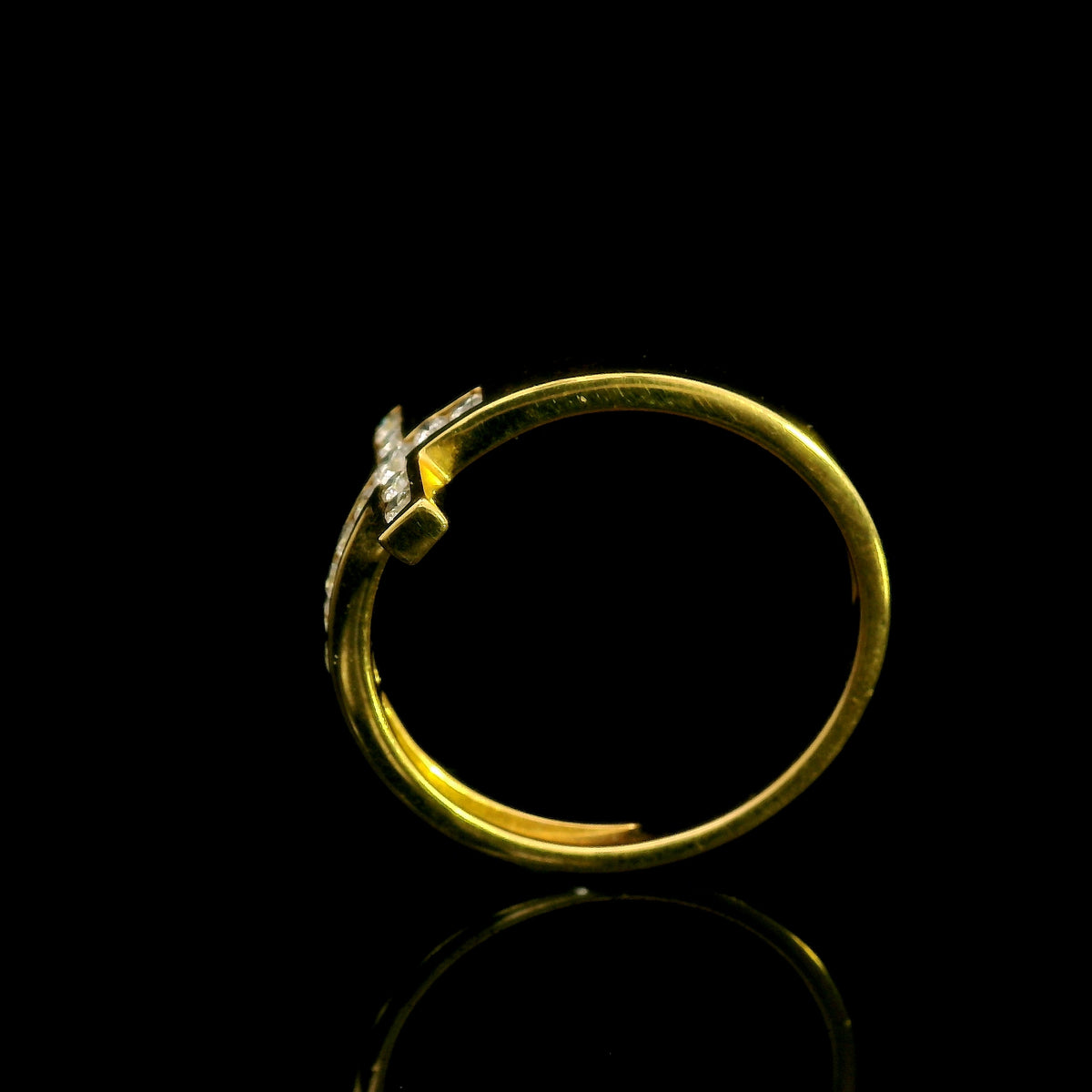 Diamond cross ring in 18K yellow gold featuring round brilliant diamonds set across a polished gold band in a distinctive cross design.
