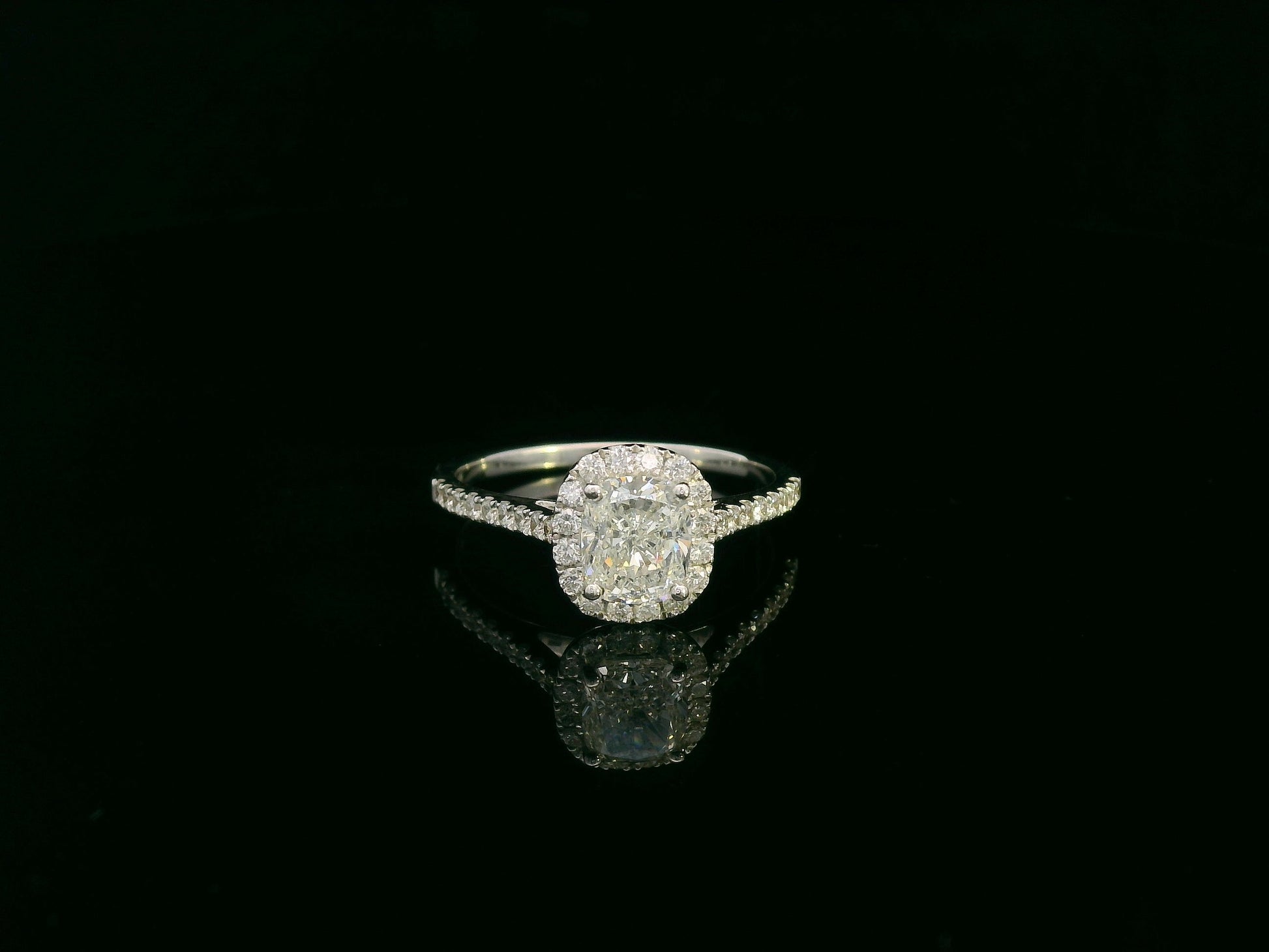 Cushion cut diamond bridal ring set in 18K white gold with diamond wedding band by Emirates Diamonds.