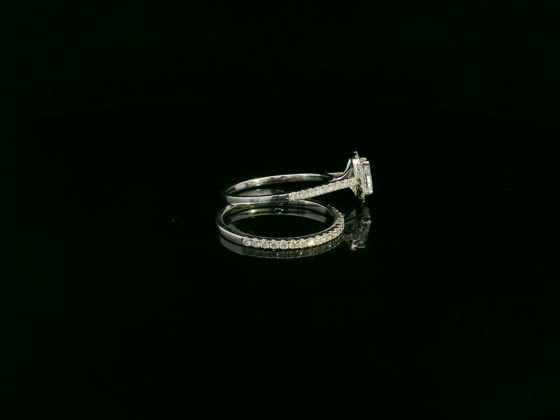 Cushion cut diamond bridal ring set in 18K white gold with diamond wedding band by Emirates Diamonds.