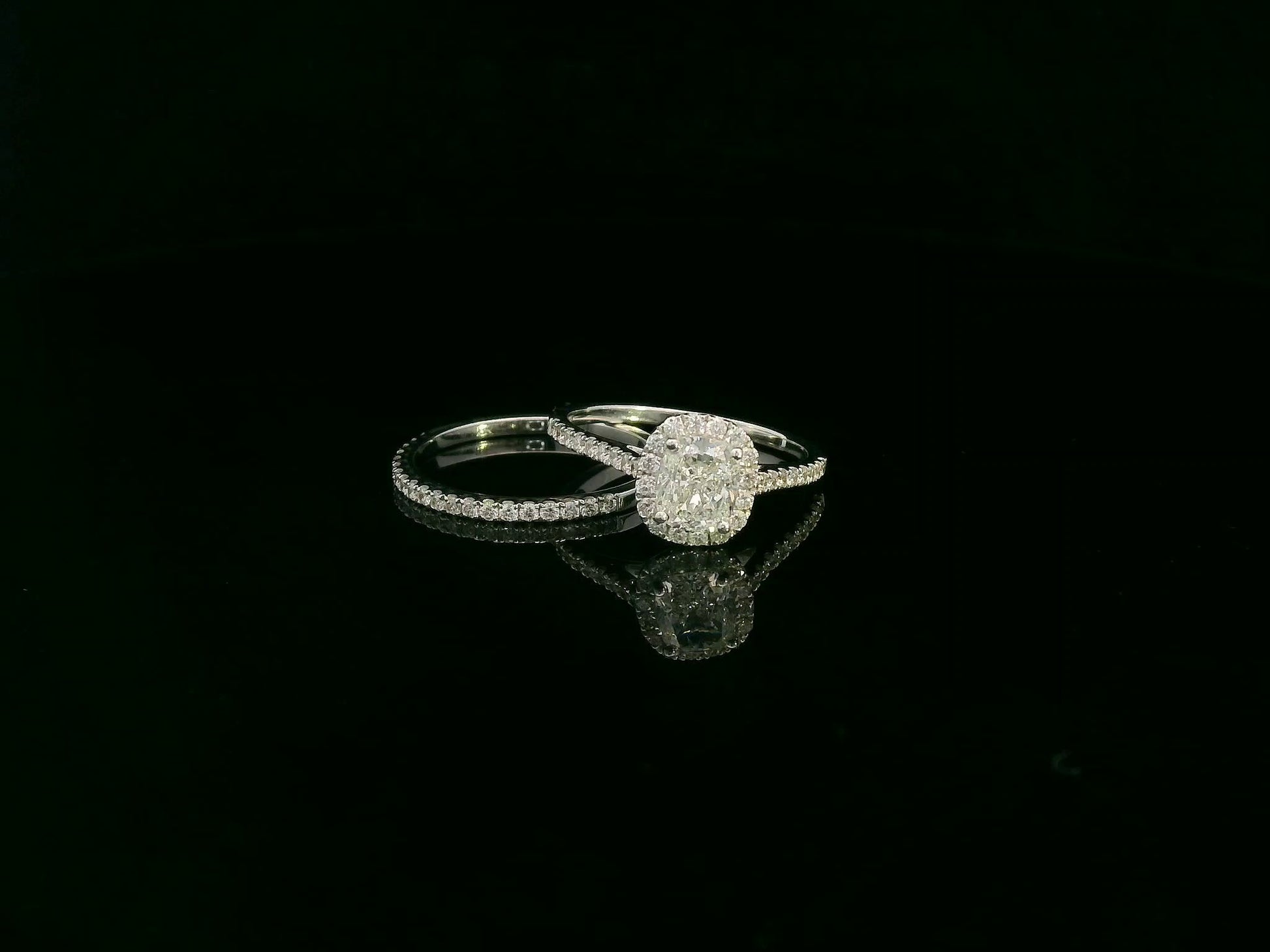 Cushion cut diamond bridal ring set in 18K white gold with diamond wedding band by Emirates Diamonds.