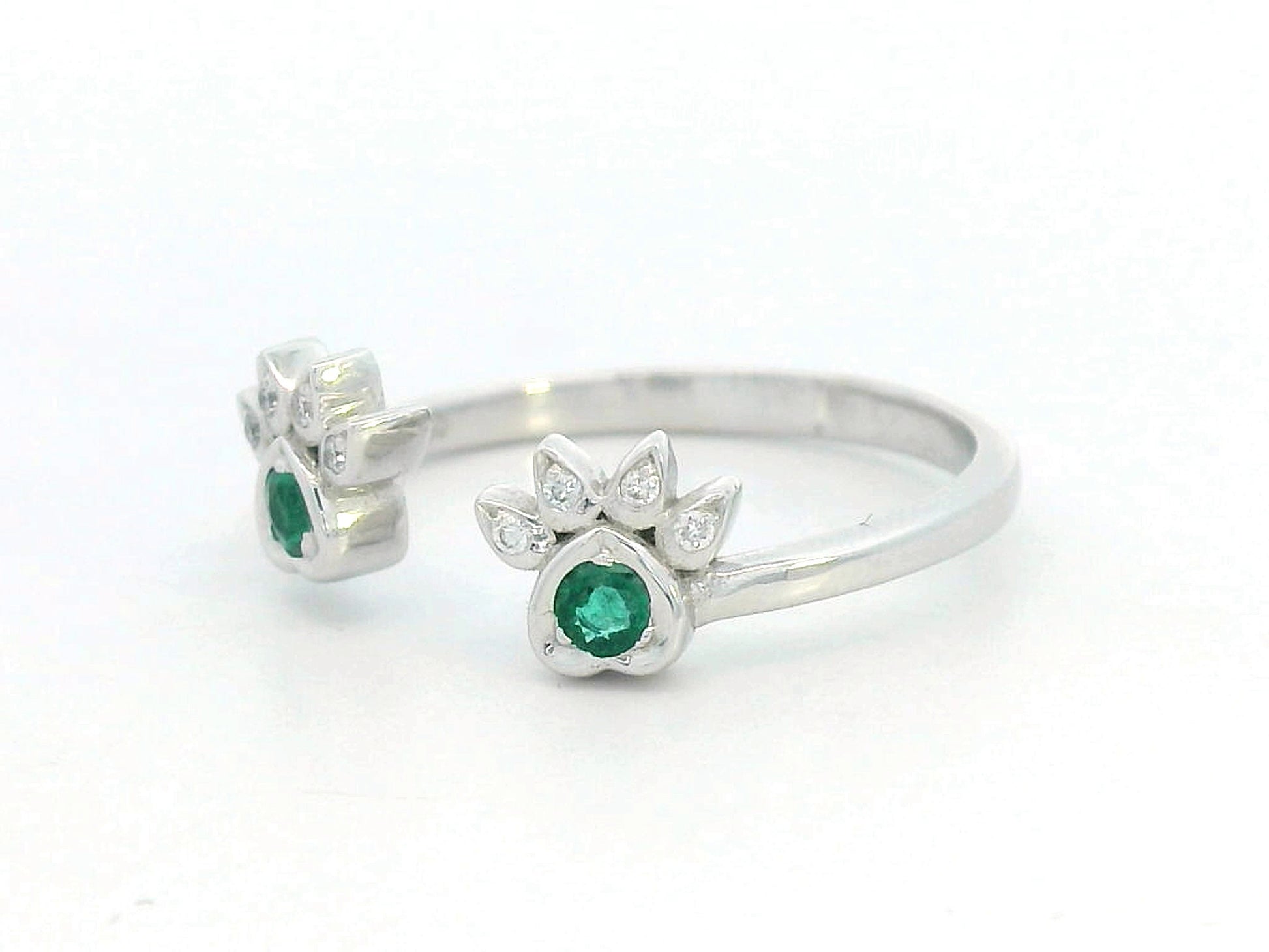 18K gold open band ring with emerald and diamond paw motifs