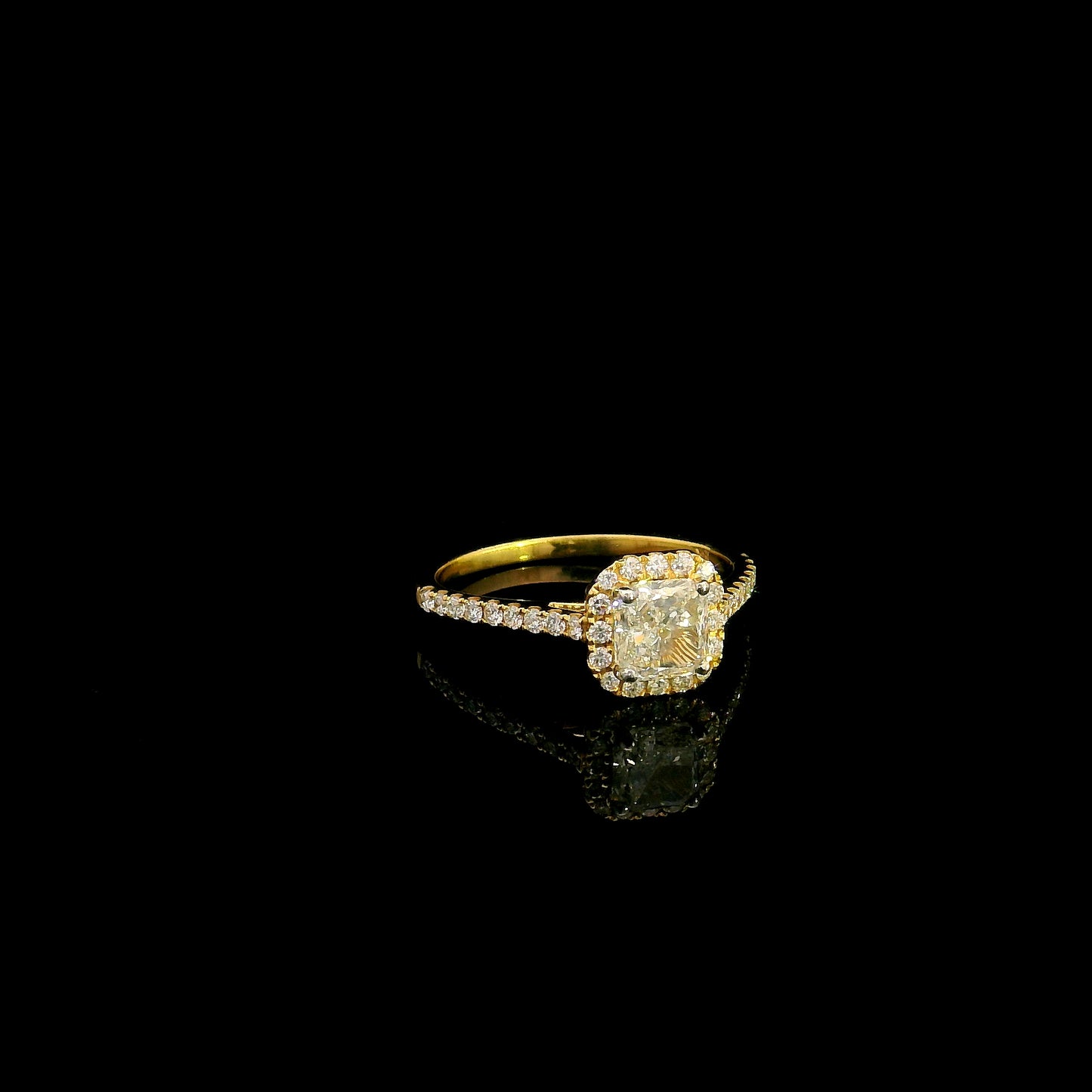 18K yellow gold radiant cut diamond halo engagement ring featuring a 1.01 carat GIA certified natural diamond with a pavé diamond band.
