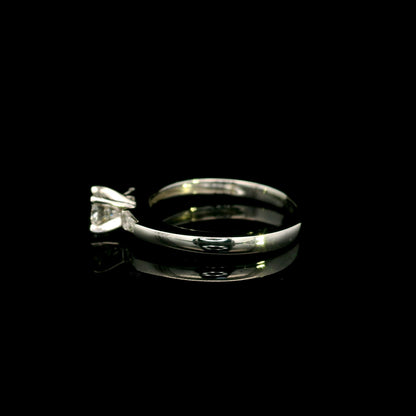 18K white gold round diamond solitaire ring with tapered baguette side diamonds and a classic elegant design.