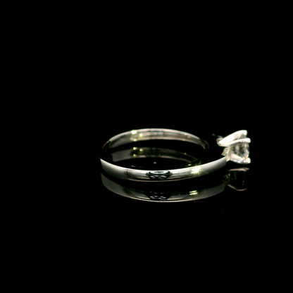 18K white gold round diamond solitaire ring with tapered baguette side diamonds and a classic elegant design.