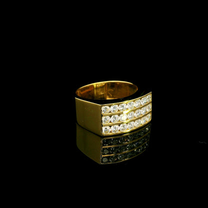 Men’s diamond statement ring in 18K yellow gold featuring three rows of round brilliant diamonds across a wide tapered gold band.