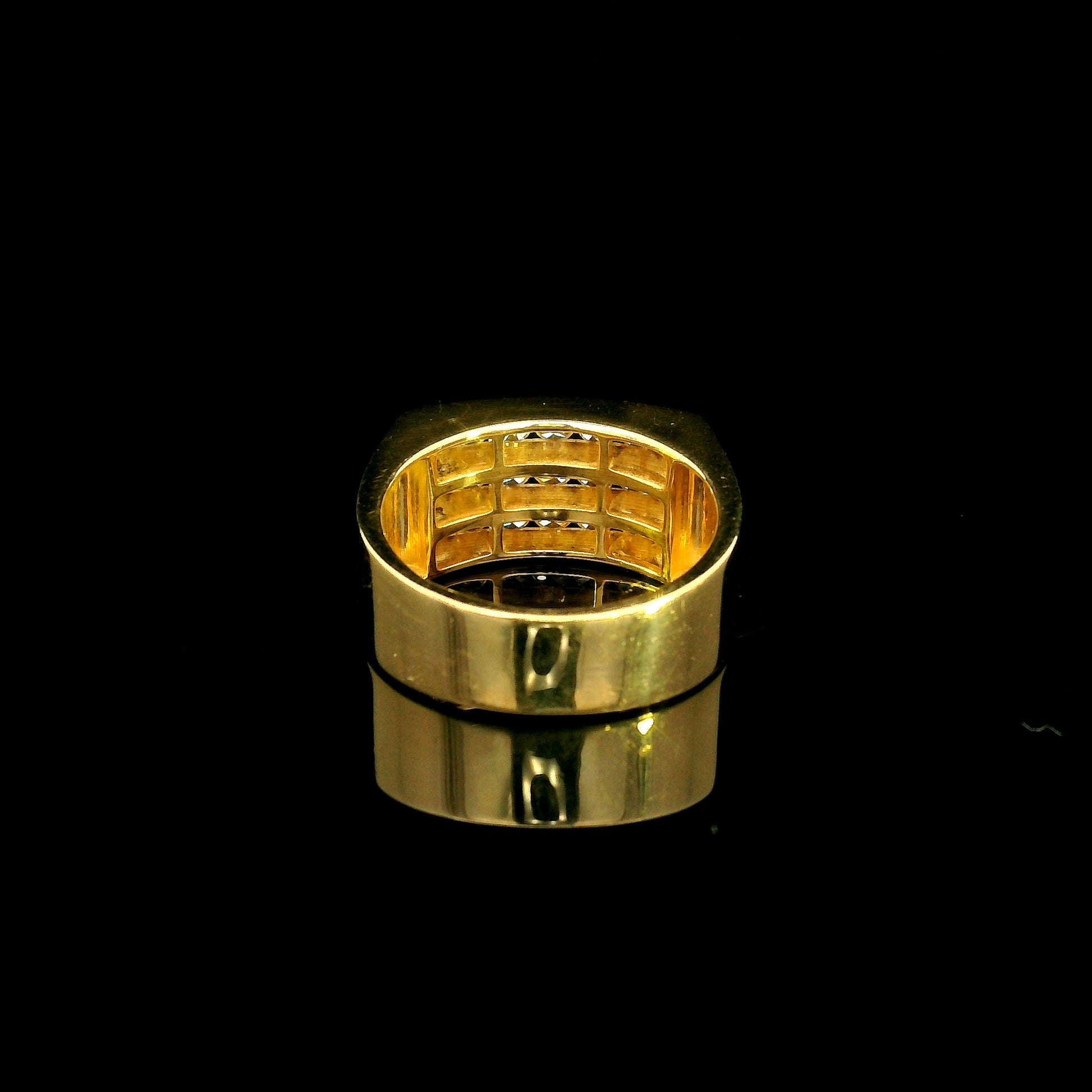 Men’s diamond statement ring in 18K yellow gold featuring three rows of round brilliant diamonds across a wide tapered gold band.